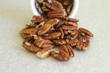 Pecans Spilling Out Of A Container, Centered