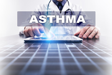 Medical doctor working with modern computer and selecting asthma. Medical concept.