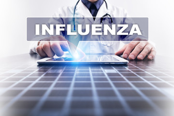 Medical doctor working with modern computer and selecting influenza. Medical concept.