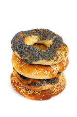 Stack of Poppy and sesame bagels on a white background