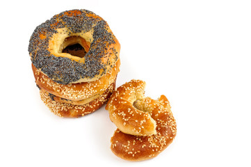 Stack of Poppy and sesame bagels on a white background