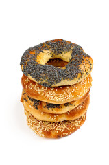 Stack of Poppy and sesame bagels on a white background