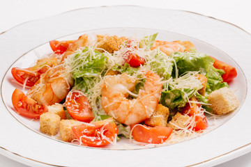 seafood caesar salad with shrimps, salad leaf, parmesan cheese