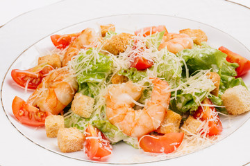 seafood caesar salad with shrimps, salad leaf, parmesan cheese 