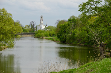 Fototapeta na wymiar Bending river and the distant Christian church