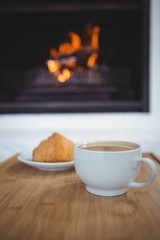 Coffee cup on table next to sweet food