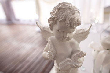 Fototapeta premium Love background. Valentine day angel statue of cupid for wedding and love backgrounds