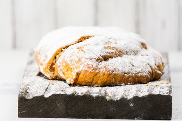 Christmas stollen over festive background. Selective focus