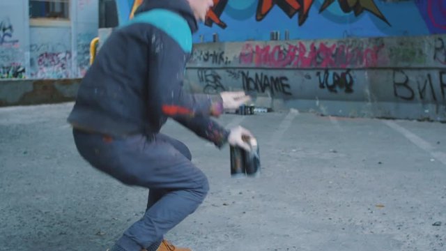 Graffiti artist using smartphone at graffiti background