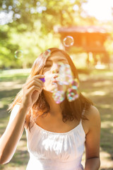 a beautiful woman blowing bubbles