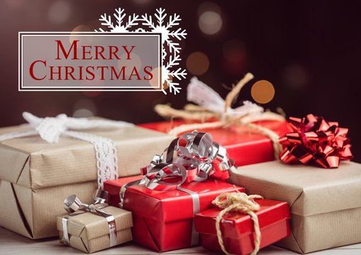 Merry christmas message against christmas gift boxes