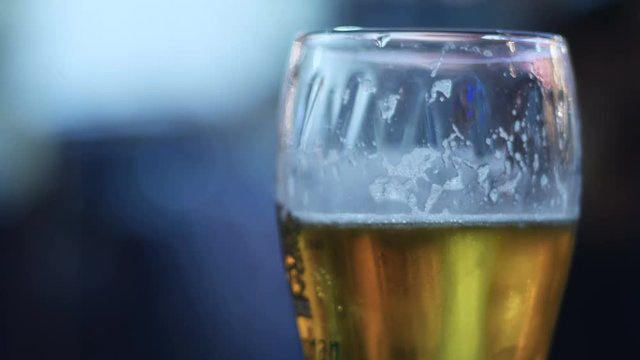 Beer Glass in a Pub. Close up of beer glass with blur background stock footage