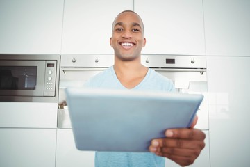 Smiling man using tablet