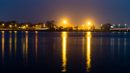 summer night city light reflections over water