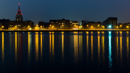 Fototapeta na wymiar summer night city light reflections over water