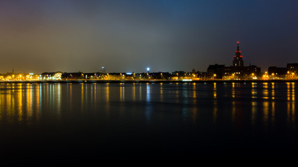 summer night city light reflections over water