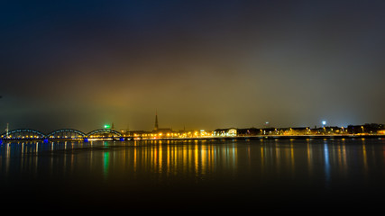 summer night city light reflections over water