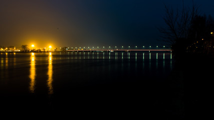 Fototapeta premium summer night city light reflections over water