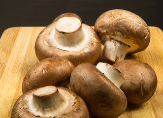 mushroom champignons on a wooden Board