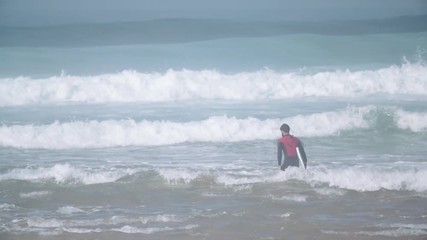 Estoril, Portugal - July 15, 2016: Surfers riding waves on July 15, 2016 in Estoril, Portugal. Powerful nature, active lifestyle and people