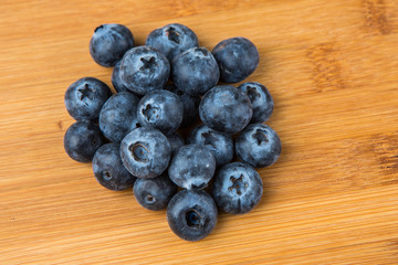 Pile of blueberries isolated on wood background