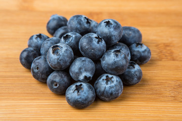 Pile of blueberries isolated on wood background