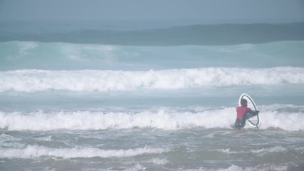 Estoril, Portugal - July 15, 2016: Surfers riding waves on July 15, 2016 in Estoril, Portugal. Powerful nature, active lifestyle and people
