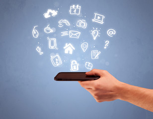 Hand holding tablet phone with drawn icons