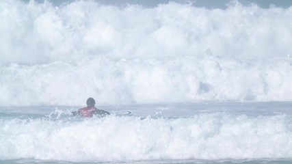 Estoril, Portugal - July 15, 2016: Surfers riding waves on July 15, 2016 in Estoril, Portugal. Powerful nature, active lifestyle and people