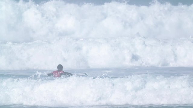 Estoril, Portugal - July 15, 2016: Surfers riding waves on July 15, 2016 in Estoril, Portugal. Powerful nature, active lifestyle and people