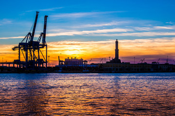sunset at Genoa's port, silhouette of the Lanterna, Italy