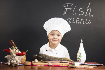 funny boy chef prepares fish