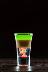 Colorful alcoholic cocktail in a shot glass
