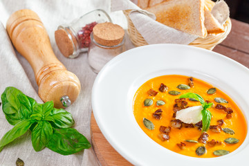 Pumpkin soup in white plate