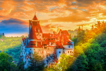 Beautiful panoramic view over Dracula Bran medieval castle in the sunset light, the most visited...
