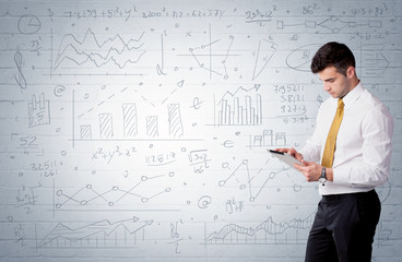 Salesman standing with drawn graph charts