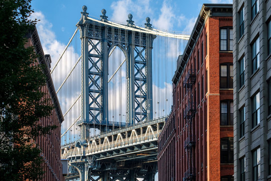 The Manhattan Bridge and a Brooklyn street sidelined by old red brick buildings