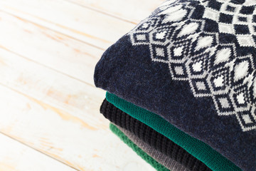 Stack of white cozy knitted sweaters