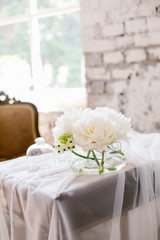 Vase with beautiful David Austin roses on a table. Nice rare white flowers for rustic wedding decoration. Loft style. Fresh romantic bouquet for bride. Blurred background.