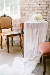 Fototapeta na wymiar Vase with beautiful white David Austin roses on a rustic wedding table. Romantic bouquet for a bride. Loft style wedding decoration.