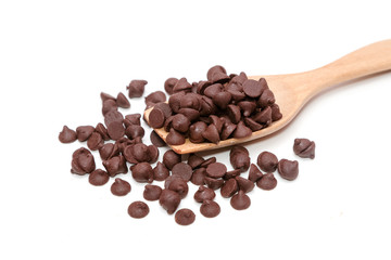 Chocolate morsels on wooden spoon isolate on white