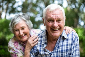 Portrait of senior couple laughing in back yard - obrazy, fototapety, plakaty