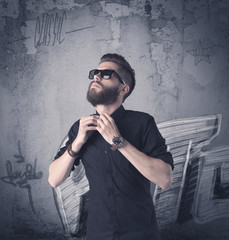 Fashion model standing at graffiti wall