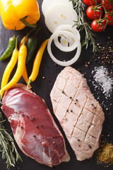 Preparation for cooking raw duck breast with ingredients close-up. vertical top view