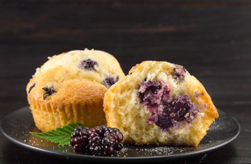 blackberry muffins covered with sugar powder