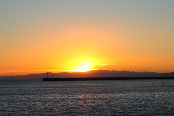 Naklejka na ściany i meble Pier silhouette in sunset background