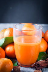 Healthy mandarin juice on wooden table