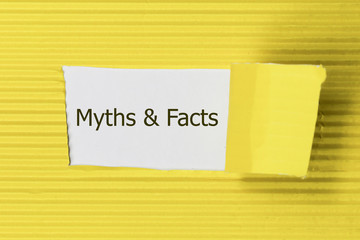 The text Facts vs myths appearing behind torn yellow paper