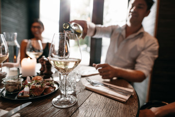 Young people having wine at restaurant