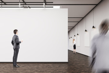 Business people in an art gallery with dark wood floor